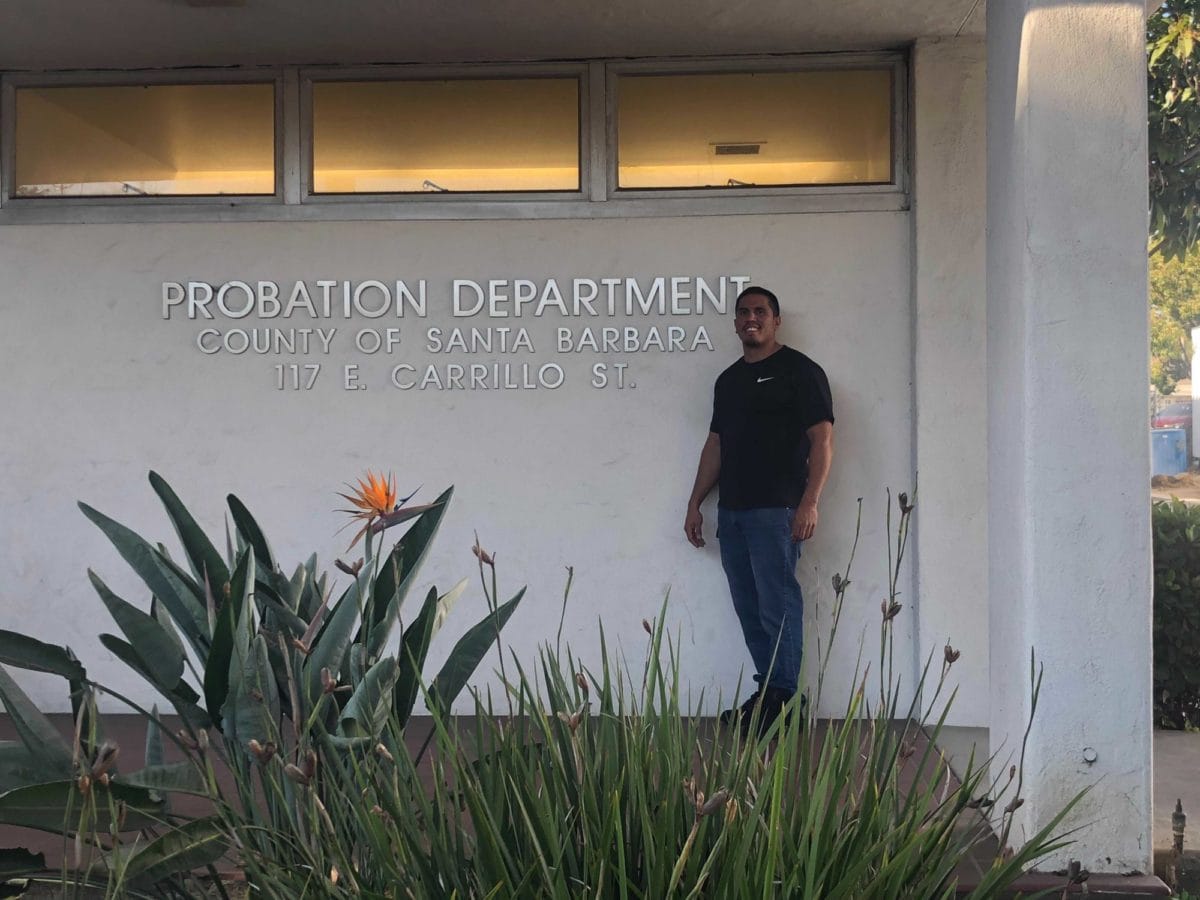 Victor stands in front of the Santa Barbara county parole office.