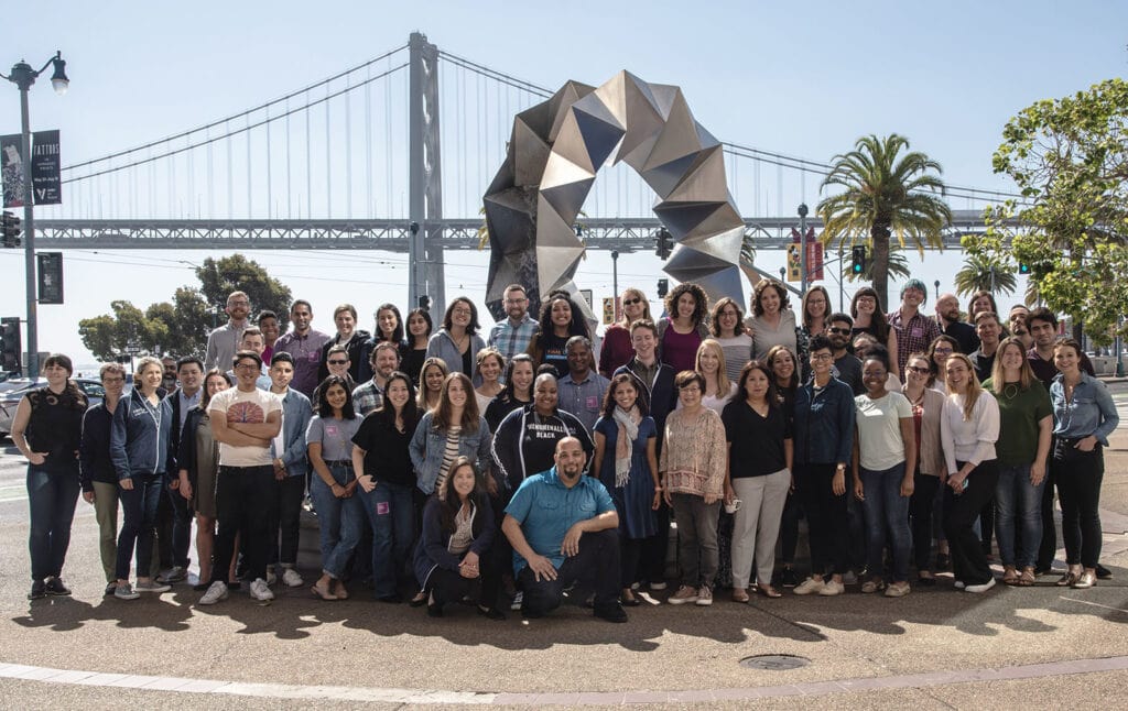 Group photo of the Code for America staff, outside with a bridge in the background