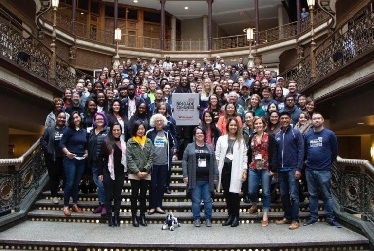Attendees at Brigade Congress 2020 pose for a group photo on a wide staircase