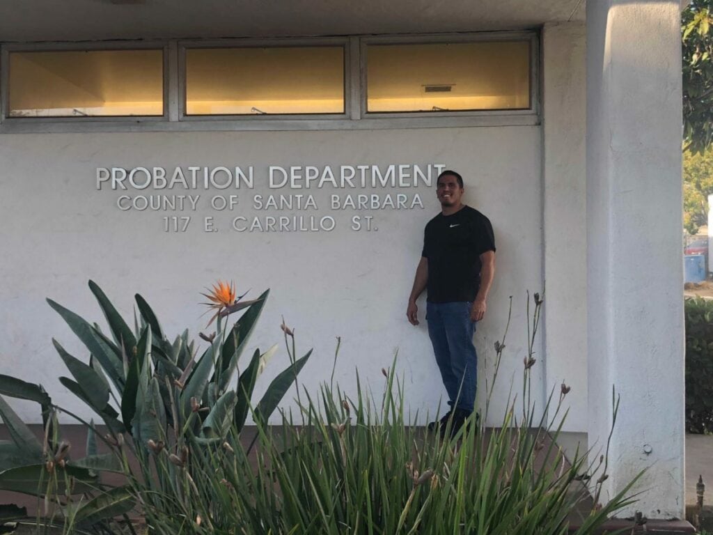 Victor stands in front of the Santa Barbara county parole office.