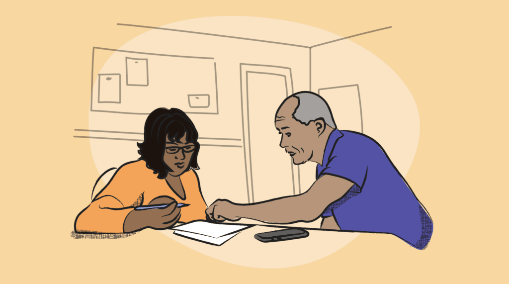 two people at work at work on paperwork