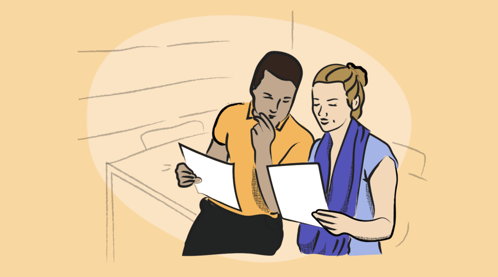 two people look at paperwork together in an office