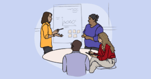 An illustration of four people, two standing and two sitting, collaborating around a table as one of the standing people points to an easel.